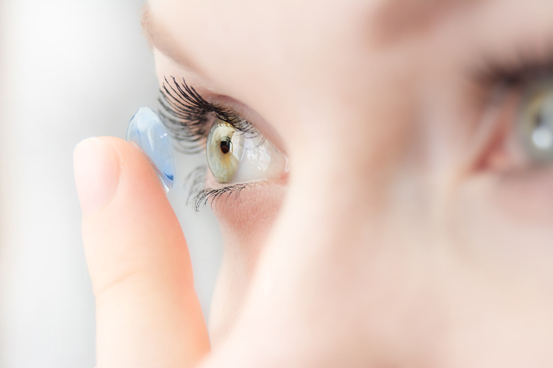 Woman putting on new contact lens in Chattanooga, TN