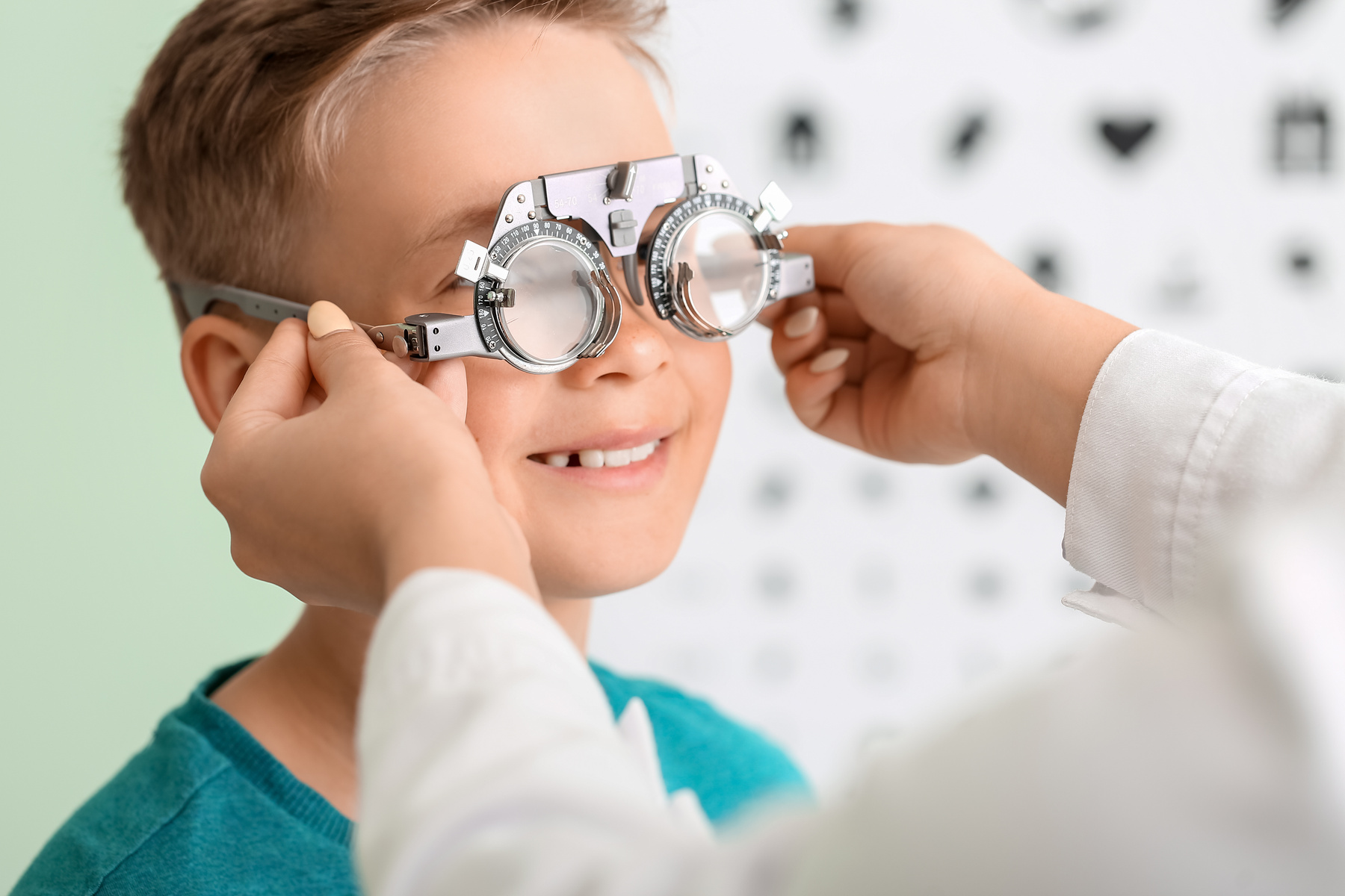 Little boy undergoing eye test in clinic happy child patient receiving a pediatric eye exam at Specs Eye Care in Chattanooga TN